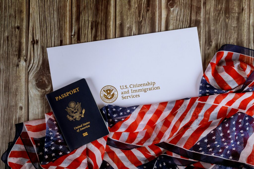 USA passport and citizenship naturalization certificate of US flag over wooden background