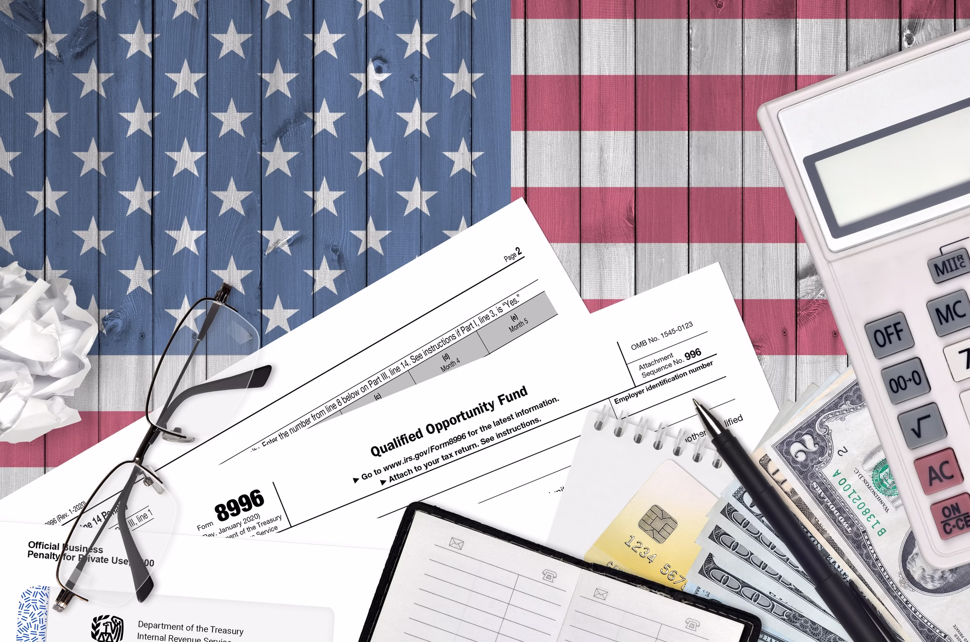 IRS form 8996 Qualified opportunity fund lies on flat lay office table and ready to fill