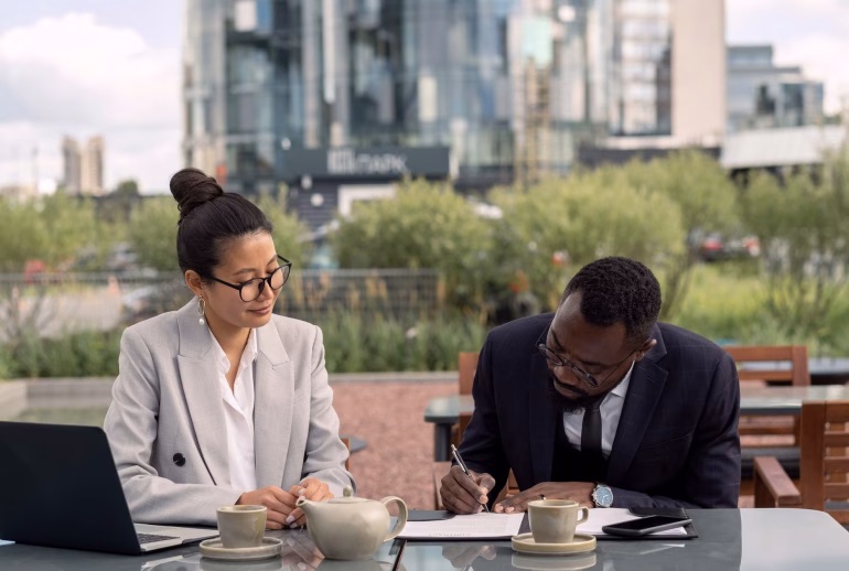 African businessman signing contract with Asian business partner